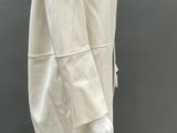 an image of a mannequin wearing a white dress and hat
