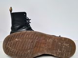 the sole of a pair of black boots on a white surface