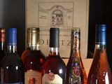 bottles of wine are lined up on a table in front of a box