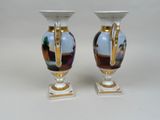 two vases that are sitting on a table