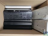 many laptops in a box with a keyboard on top of them