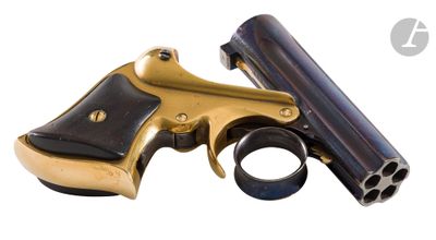 a gun that is sitting on a white surface