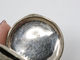 a person holding a silver object in their hand
