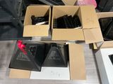 several boxes of electronic equipment are sitting on a wooden floor