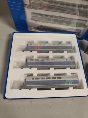 une boîte contenant un circuit de train, posée sur une table