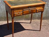 a small wooden table with two drawers on top of it