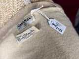 a close up of the label on the back of a beige sweater