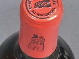 a bottle of wine that has a red label on it