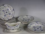 a group of blue and white china dishes and saucers