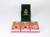 three boxes with rings inside of them on a white surface