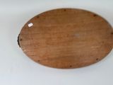 a wooden plate with holes on it sitting on a table