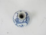 a small blue and white vase with a tag on it