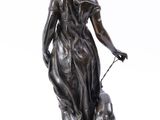 a bronze statue of a woman with a dog on a marble base