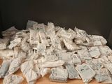 a pile of bags of food on a wooden table