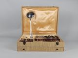 a wooden box with silverware in it and a spoon in it
