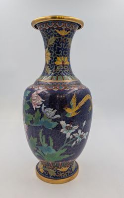 a blue vase with flowers and birds painted on it