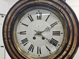 a clock that is on a wooden pole in a room