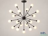 a large black chandelier with white bulbs hanging from the ceiling