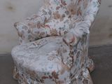 a chair with a ruffled seat in front of a wall