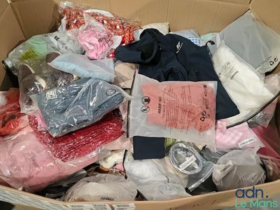 a cardboard box filled with clothing and other items