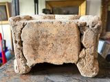 a stone block sitting on top of a shelf in a room