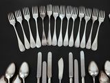 a lot of forks and spoons arranged in a circle