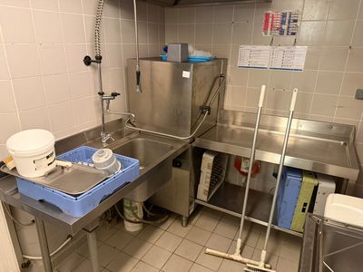 a kitchen with a sink and a refrigerator in it