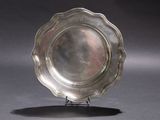 a silver plate that is sitting on a stand