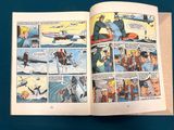 a comic book open to a page with a picture of a man on a plane