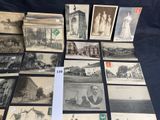 some old postcards of people and buildings are on a table