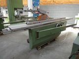 a machine that is cutting a piece of wood in a factory