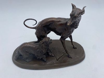 bronze statue of a dog and a cat on a plate