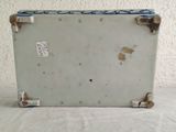 a white suitcase with a blue handle sitting on a table