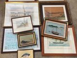 many framed pictures on the floor next to each other