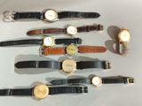several different types of watches are arranged in a row on a table