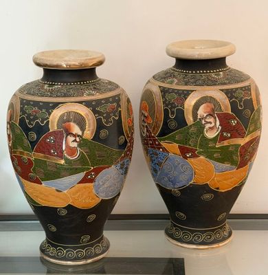 two vases that are sitting on a glass table