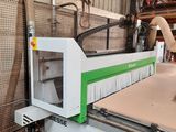 a machine that is cutting a piece of wood