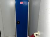 a blue locker in a bathroom with a towel on the floor