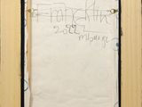 an old picture frame with a piece of paper taped to it