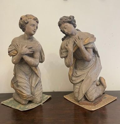 two statues that are sitting on a wooden table