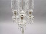 a glass candelab with a candle holder on it
