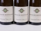 three bottles of wine sitting on top of a white table