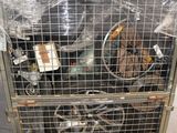 a metal cage with a bunch of items inside of it