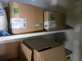 many boxes on a shelf in a room