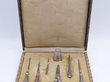 five pairs of scissors and a pair of scissors in a box