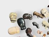 many different types of animal figurines displayed on a white surface