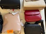 a lot of purses on a table with price tags
