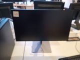 a computer monitor sitting on top of a desk next to a keyboard and mouse