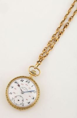 a close up of a gold pocket watch on a chain
