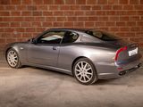 a silver sports car parked in front of a brick wall